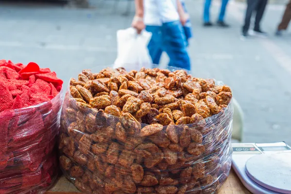 Mexican sweets displayed in a colorful Mexican market stall, featuring caramelized pecans, typical in local traditional sweets.